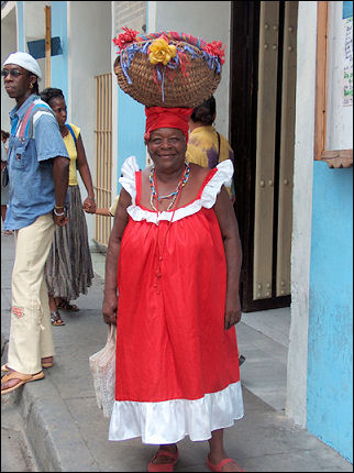 Cuba - Santiago de Cuba, black woman with basket on her head