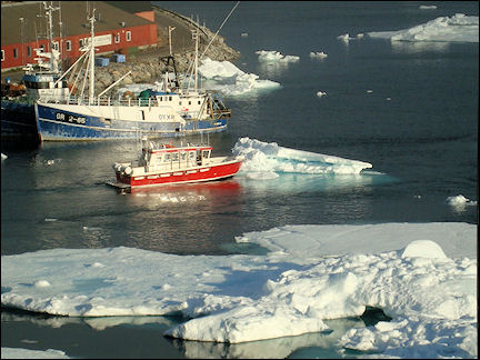 Greenland - Boat pushes iceberg out of Qaqortoq harbor