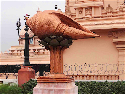 India, Delhi - A huge conch shell perched on top of a concrete columna