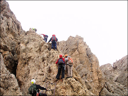 Italy, Dolomites - Climbing over ladders to the Gardena Pass peak of Cir Spitz