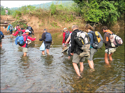 Laos - Wading through a river to the other side