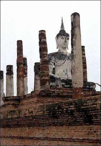 Thailand - Large statue amidst the ruins in Sukothai