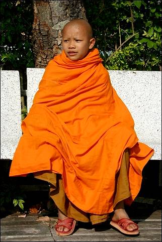 Thailand - Tha Ton, young monk on bench